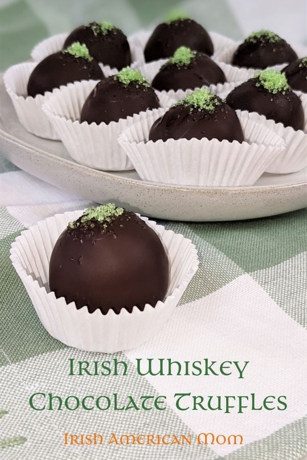 Chocolate covered whiskey truffles | Irish American Mom Chocolate truffles with green sprinkles in paper cases