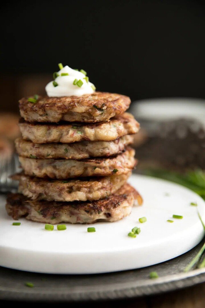 Stack of potato pancakes with sour cream