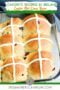 Tray of freshly baked hot cross buns with white icing crosses on top, labeled as a favorite Irish Easter recipe.
