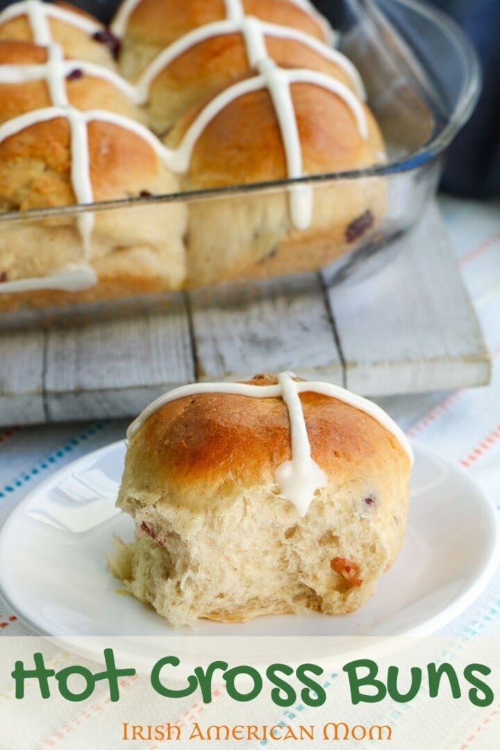Bread machine hot cross buns with one on a plate