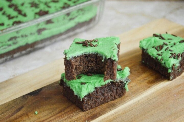 Irish Brownies for Saint Patrick's Day | Irish American Mom Brownies with green frosting and chocolate sprinkles on a cutting board