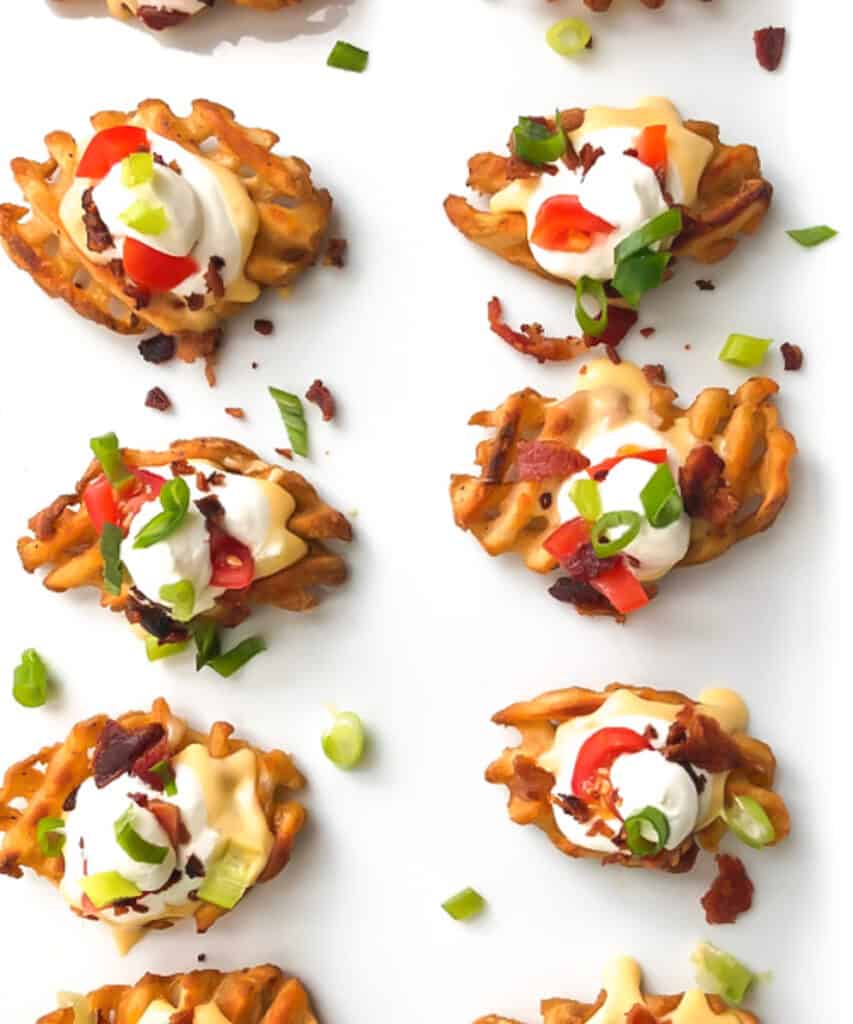 Waffle fries with sour cream and pepper toppings