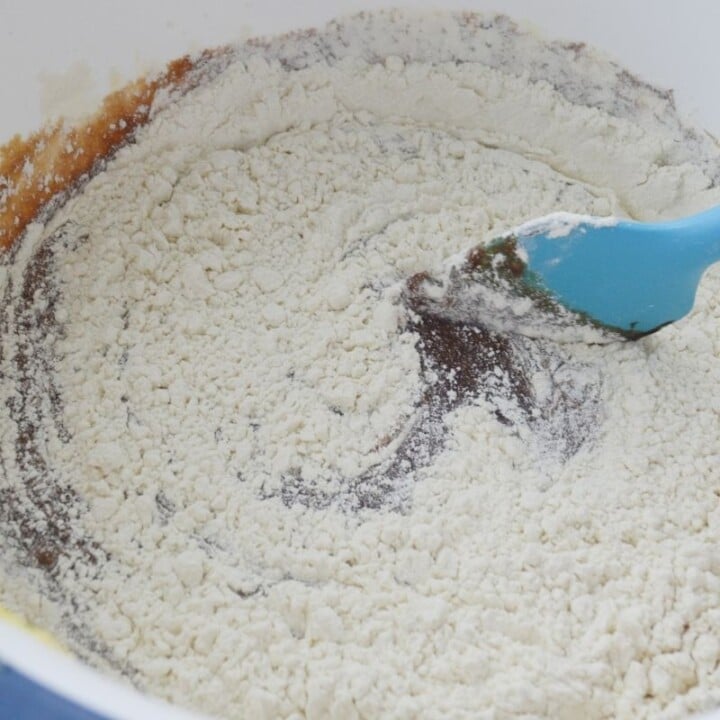 Mixing brownies mixture in a bowl for Irish brownies | Irish American Mom Adding flour to brownie batter