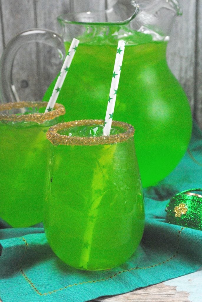 Green drinks in glasses with straws plus a pitcher of green liquid