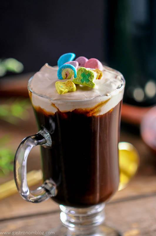 Irish coffee in a glass with a garnish of lucky chamrs