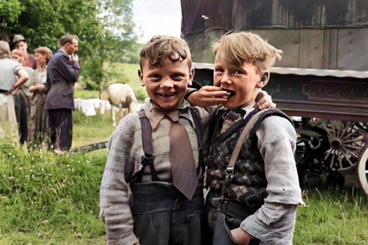 Two Irish Boys Vintage Image in Color | Irish American Mom Two boys in a field with a group of people and a caravan
