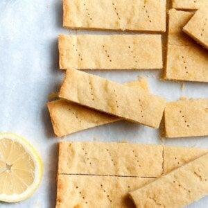 Slices of lemon shortbread beside a lemon half