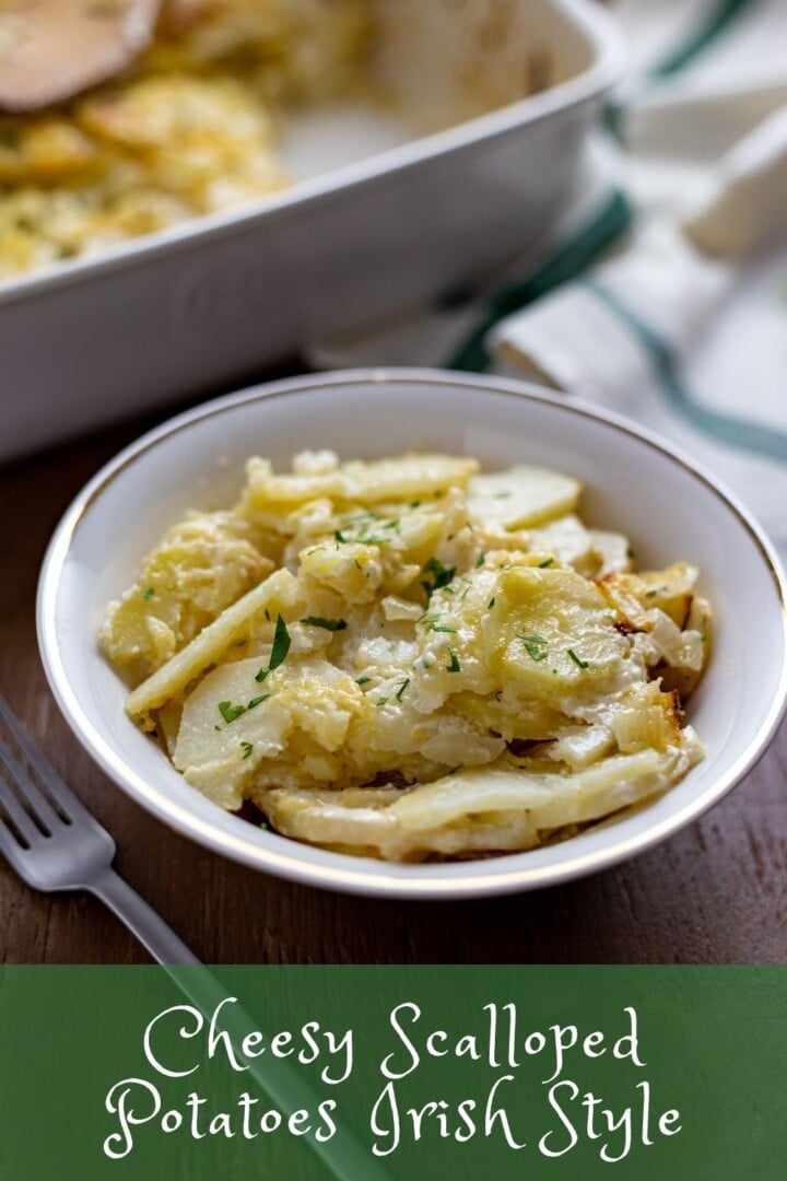 Serving of Cheesy Scalloped Potatoes Irish Style with a shamrock dish towel | Irish American Mom Serving of cheesy scalloped potatoes with text overlay
