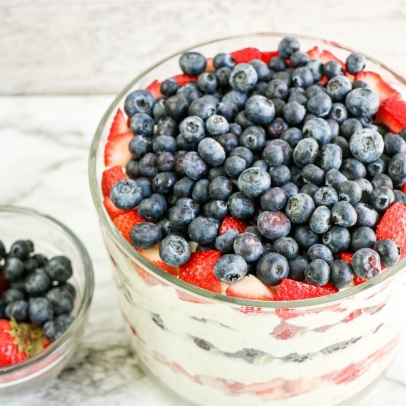 Blueberries decorating the top of a patriotic trifle | Irish American Mom Looking down on a trifle with blueberry and strawberry toppings