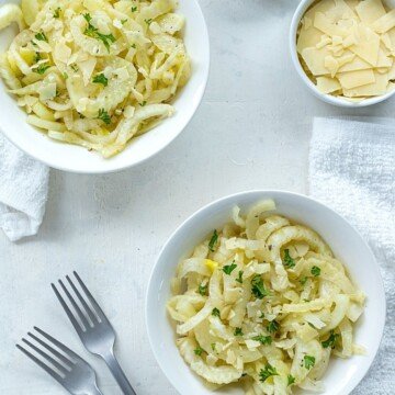 Bowls ov fennel salad beside Parmesan shavings