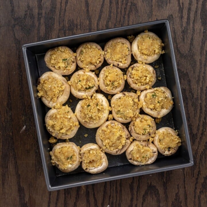 Cheese stuffed mushrooms in a baking pan | Irish American Mom Mushtooms stuffed with cheese and breadcrumbs in a baking pan