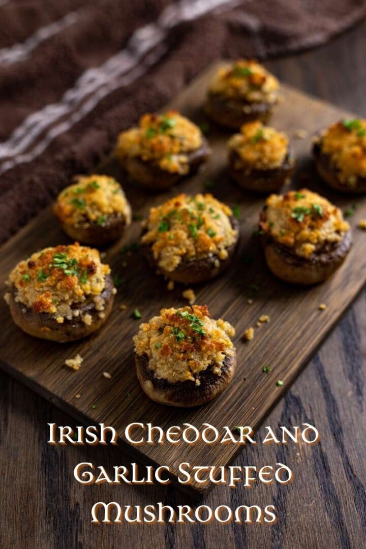 Irish Cheddar and Garlic Stuffed Mushrooms Served on a Board | Irish American Mom Musrhooms with cheese stuffing on a board with text overlay