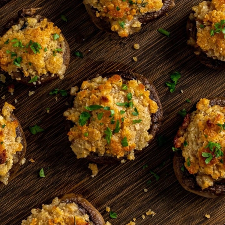Irish cheddar cheese stuffed mushroom recipe with parsley garnish | Irish American Mom Stffed mushrooms on a chopping board
