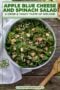 Single-image poster of apple blue cheese spinach salad styled with Celtic design accents in cream, forest green, and warm amber tones.