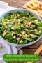 Bowl of spinach salad with apple plus text banner