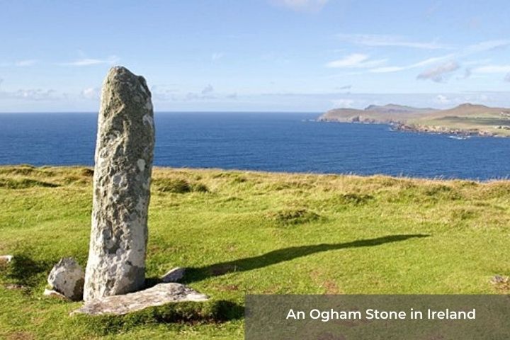An Ogham stone in Ireland | Irish American Mom A standing stone in a field beside the ocean