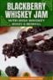 Close-up of glossy blackberry whiskey jam being scooped from a bowl, with a bold green banner at the top reading 'BLACKBERRY WHISKEY JAM' and smaller text about Irish whiskey and 'boozy & berriful'