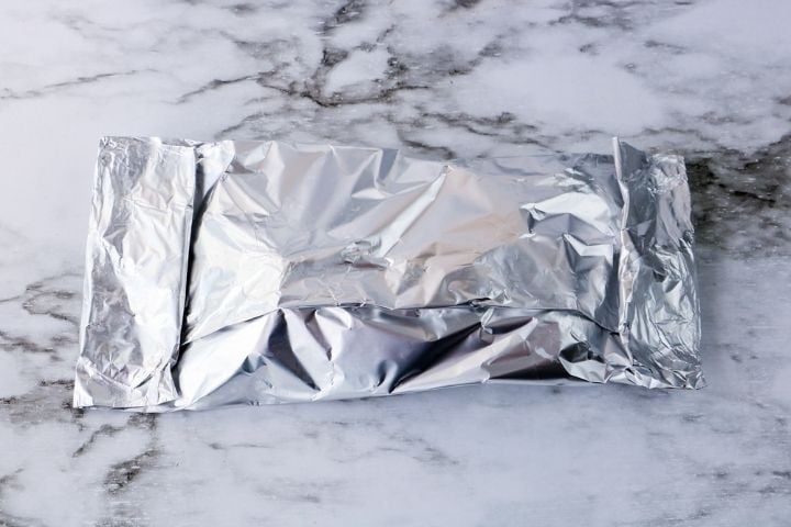 Foil packet of potatoes for grilling on a barbeque | Irish American Mom Folded cooking foil packet of food on a counter