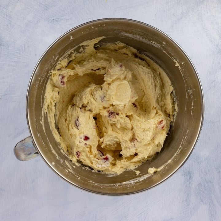 Cherries added to batter for Irish Cherry tea cake | Irish American Mom Cherry cake batter in a mixing bowl