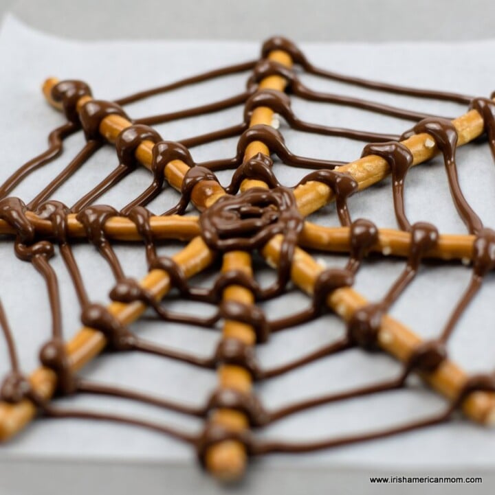 Chocolate spider web made with pretzel sticks for Halloween | Irish American Mom Pretzel stick spider web with chocolate strands