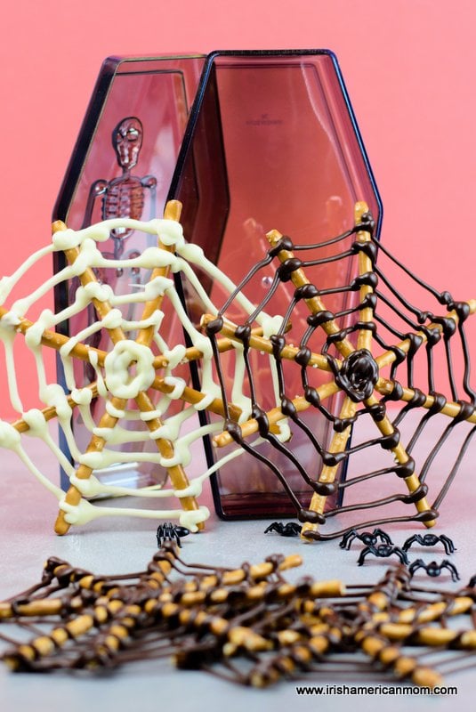 Spider webs made with chocolate and pretzel sticks | Irish American Mom Chocolate and pretzel stick spider webs displayed beside a toy tomb