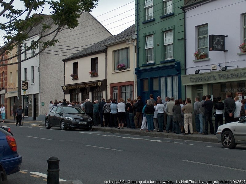 Lining up outside an Irish home to pay respects at an Irish Wake | Irish American Mom People in a line outside buildings in a town