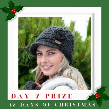 Woman wearing a knitted hat with text