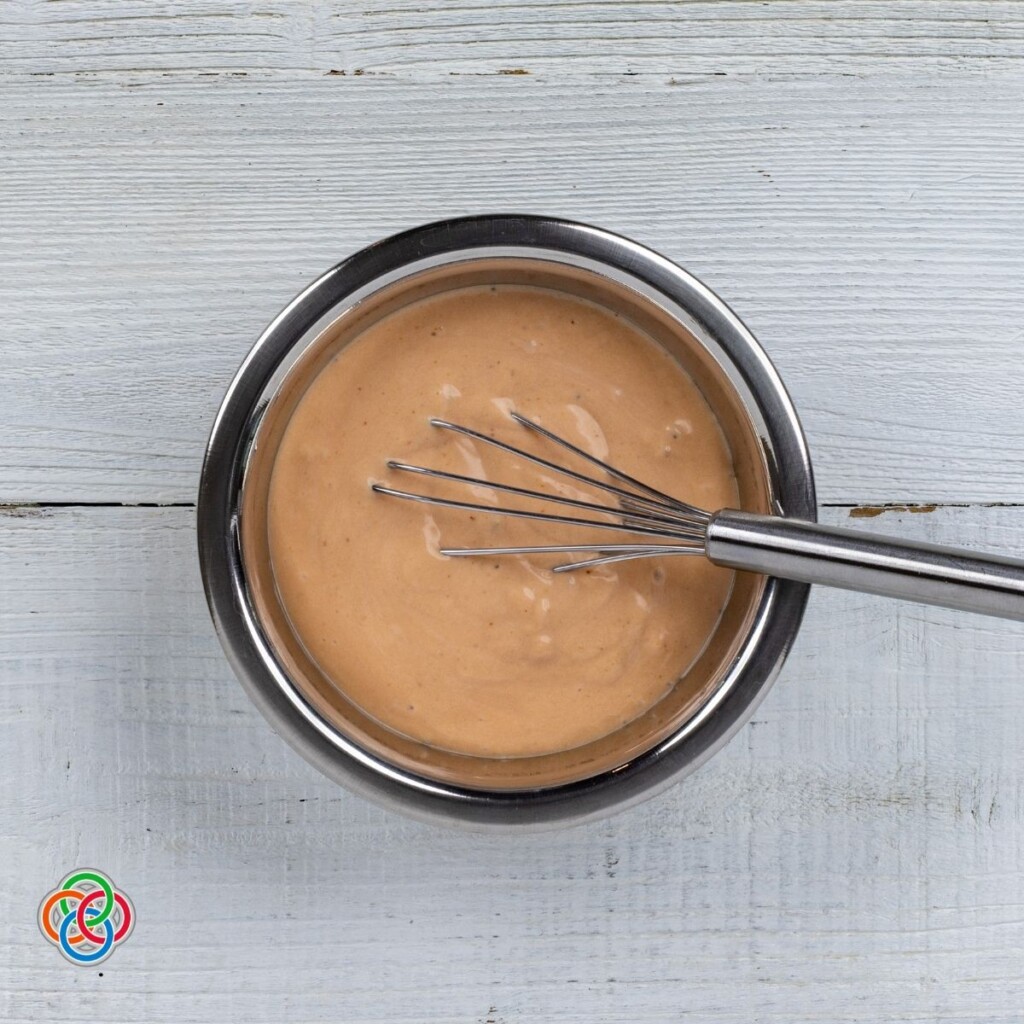 Marie Rose sauce or cocktail sauce mixed in a bowl | Irish American Mom Red sauce in a bowl with a whisk