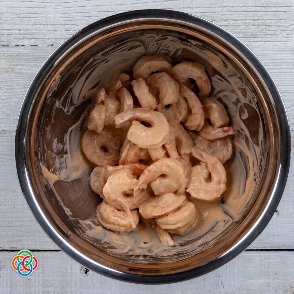 Shrimp tossed in Marie Rose sauce or cocktail sauce | Irish American Mom Cooked shrimp tossed in sauce in a bowl