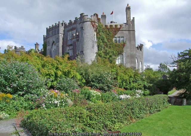 Stone castle surrounded by flowers and plants