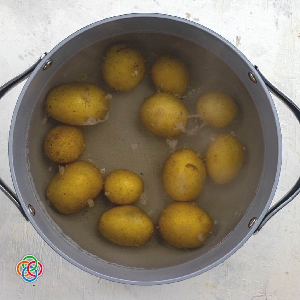 Boiling unpeeled potatoes for parsley potatoes | Irish American Mom Potatoes covered in water in a pot
