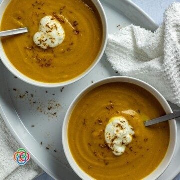 Yogurt garnish on lentil soup in bowls