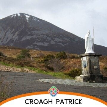 Statue on a pedastal by a mountain with text banner