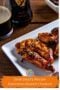 Close-up of Guinness glazed chicken on a white platter with a glossy caramelized glaze and a glass of stout in the background, labeled Irish Party Recipe Guinness Glazed Chicken with Irish American Mom branding.
