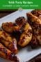 Plate of caramelized Guinness glazed chicken strips on a white platter with dipping sauce and a glass of stout in the background, labeled Irish Inspired Recipes Guinness Glazed Chicken Strips with Irish American Mom branding.