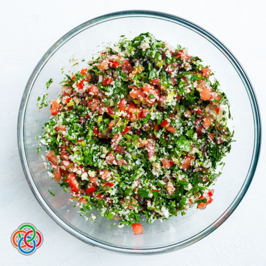 Mixing tabbouleh or tabouli in a bowl | Irish American Mom Bulgur wheat and parsley salad in a bowl