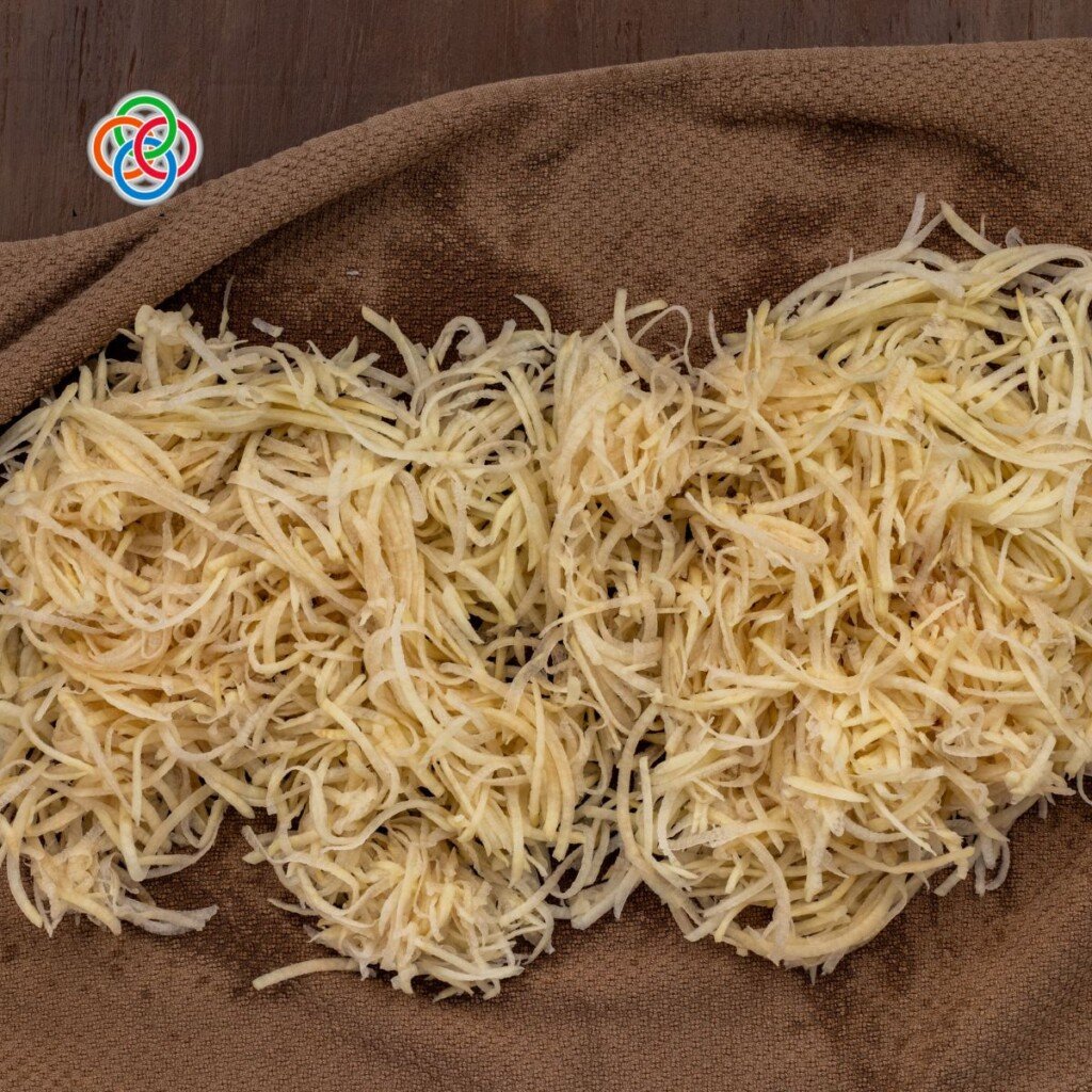 Shredded or grated potatoes on a dish towel | Irish American Mom Grated potatoes on a dish towel
