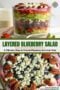 Glass jar layered blueberry salad with greens, berries, onions, pecans and crumbly cheese; overlaid text reads 'Layered Blueberry Salad' and subtitle 'A Vibrant, Easy & Crowd-Pleasing Summer Side'