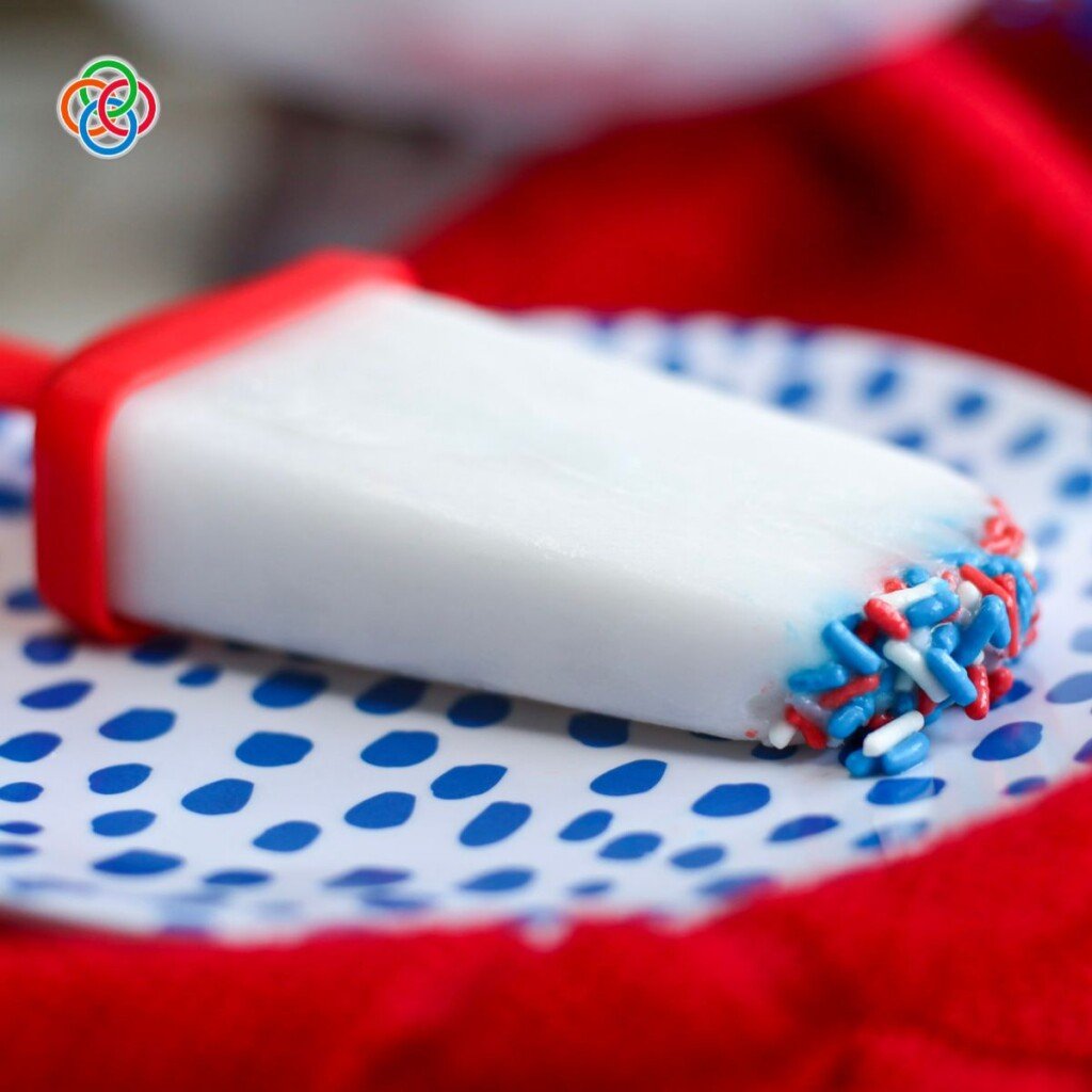 Red white and blue patriotic popsicles | Irish American Mom Patriotic popsicle with sprinkles on a plate