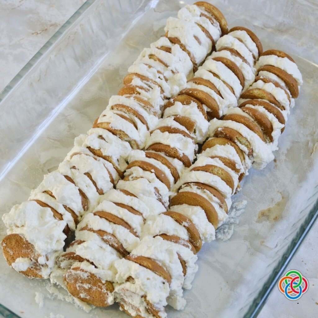 Rows of vanilla wafer and cream sandwiches casserole dish for ice box cake | Irish American Mom Rows of vanilla wafer cream sandwiches