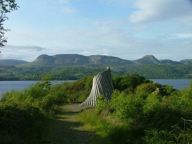 Mountain and lake with a sculpture on the shore