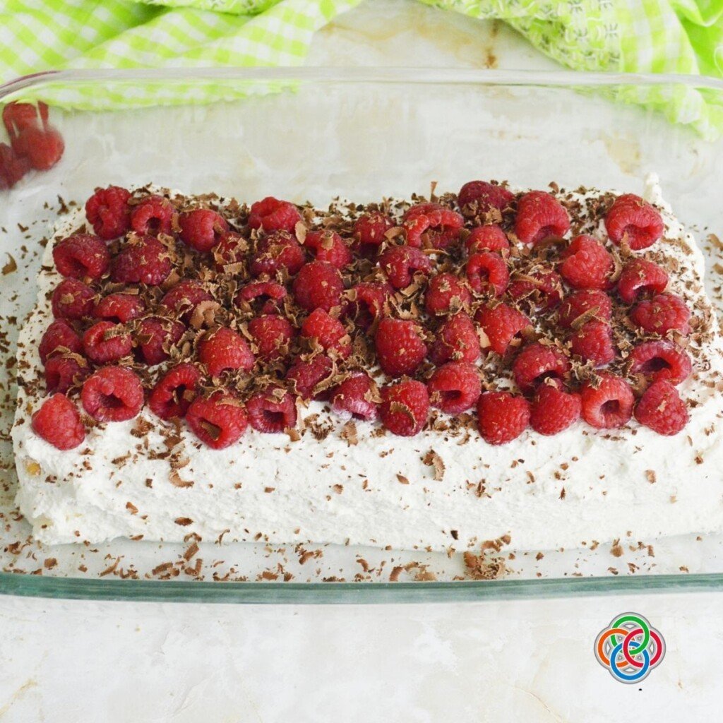 Topping a raspberry ice box cake with chocolate shavings | Irish American Mom Chocolate shavings on a raspberry ice box cake