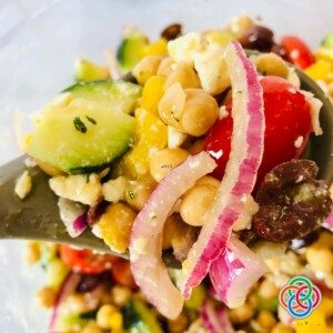 Tossing a chickpea salad with a spoon