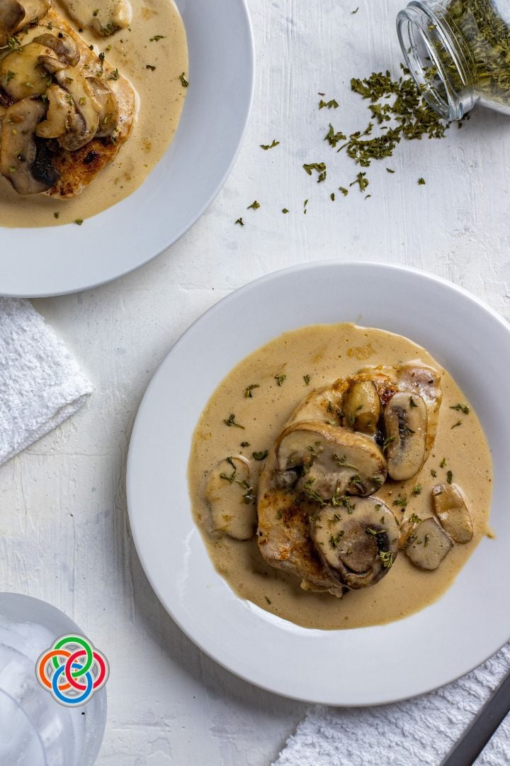 Irish whiskey pork chops | Irish American Mom Overhead shot of plates with pork chops in a cream sauce