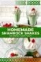 Shamrock mint shakes in tall glass goblets topped with whipped cream and a cherry, with a bold green banner reading 'Homemade Shamrock Shakes' and subtitle 'The perfect minty treat!'