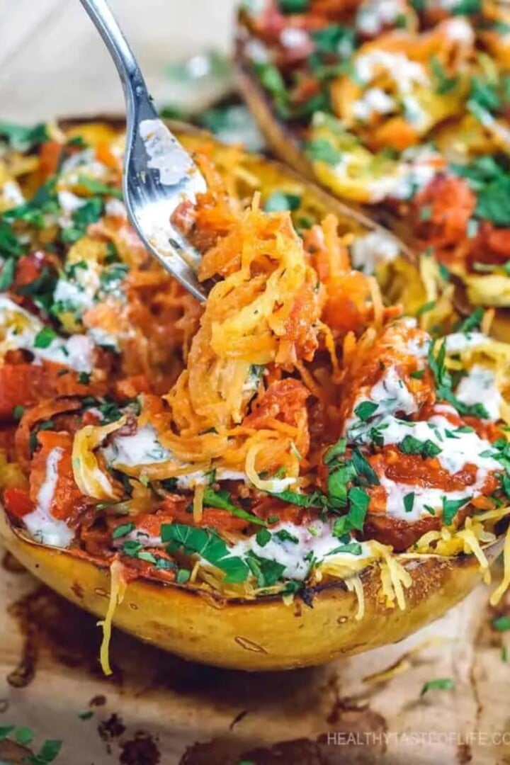 Spaghetti Squash with Chicken and BBQ Sauce | Irish American Mom Fork lifting savory filling from a squash half