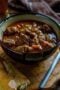 Bowl of beef stew with text banner