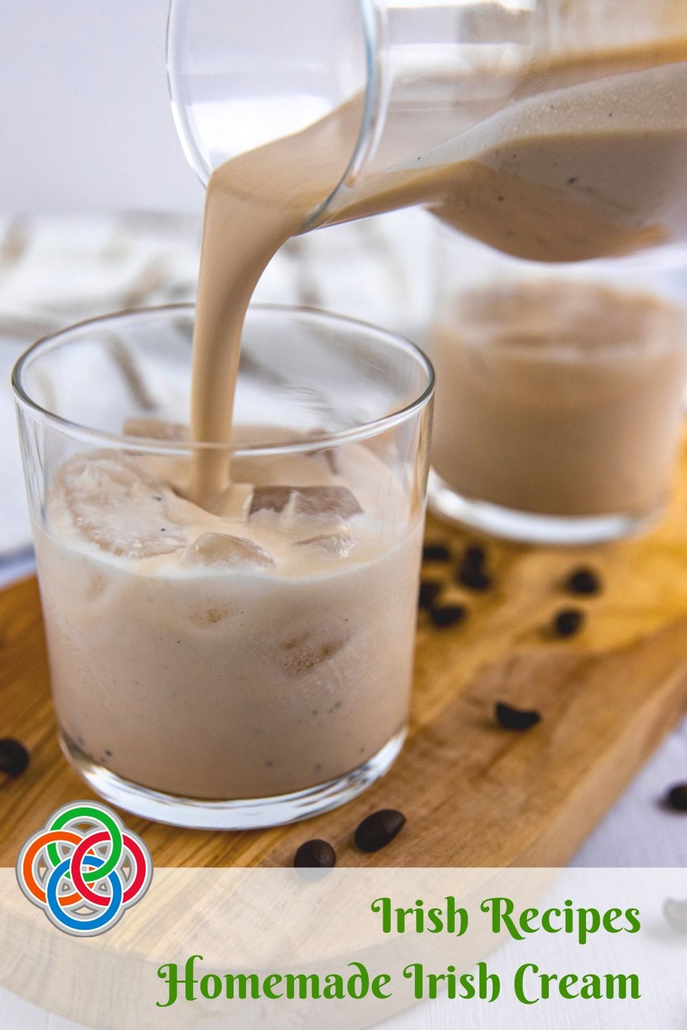 Pouring Irish cream liqueur into a glass on a board with coffee beans plus a text banner