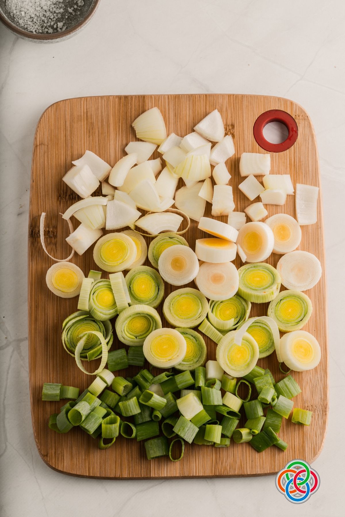 Chopped leeks onions and green onions for homemade vegan vegetable stock cubes | Irish American Mom Chopped onions, leeks and green onions on a chopping board