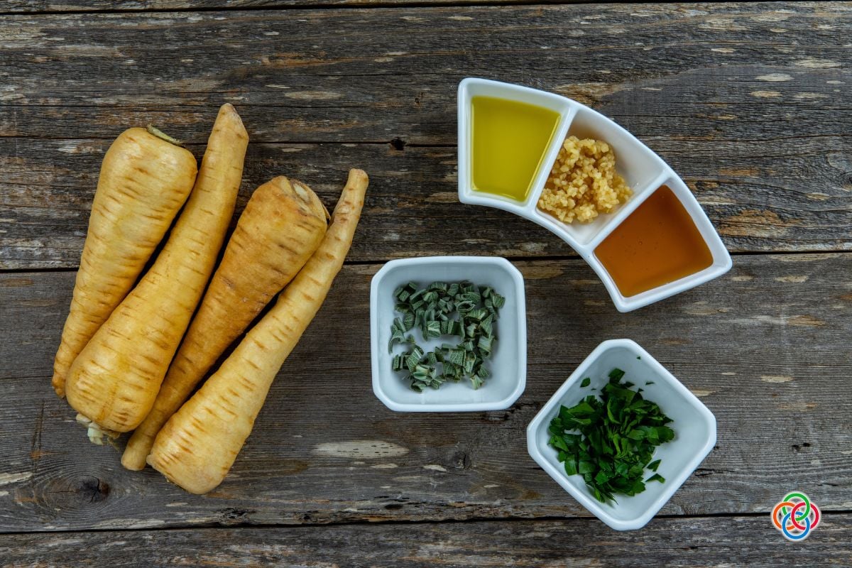 Ingredients for Honey Roasted Parsnips | Irish American Mom Parsnips with bowls of chopped herbs, garlic, oil and honey.